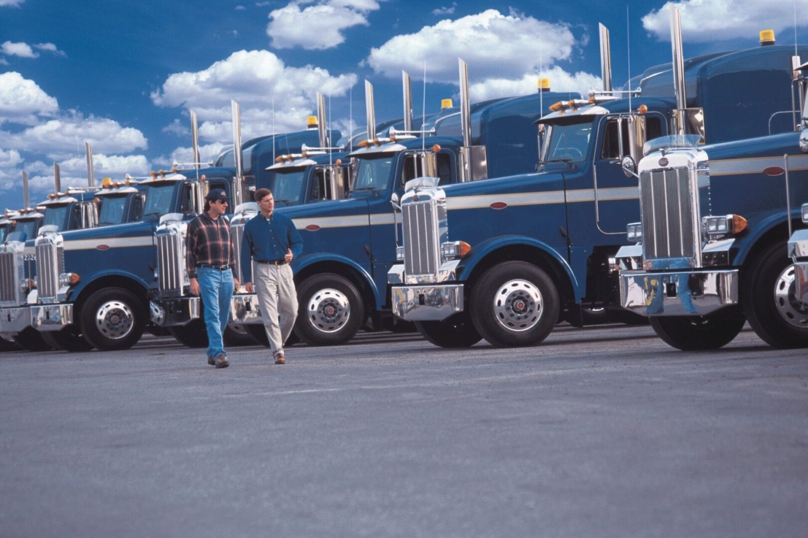 A group of trucks parked in front of each other.